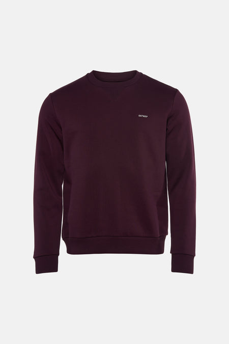 Bordeaux crewneck sweatshirt by ANTWRP with small white logo on chest, ribbed cuffs and hem, front view