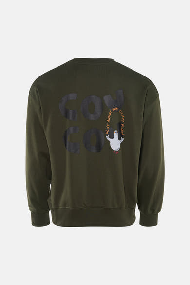 Kaki sweatshirt van ANTWRP, met "don't annoy the crazy pigeon" print op de rug.