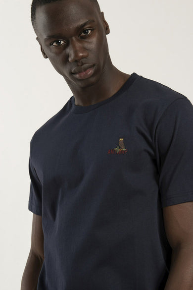 Navy blue short-sleeve t-shirt with small owl and "ANTWERP" embroidery on chest, worn by model in front view