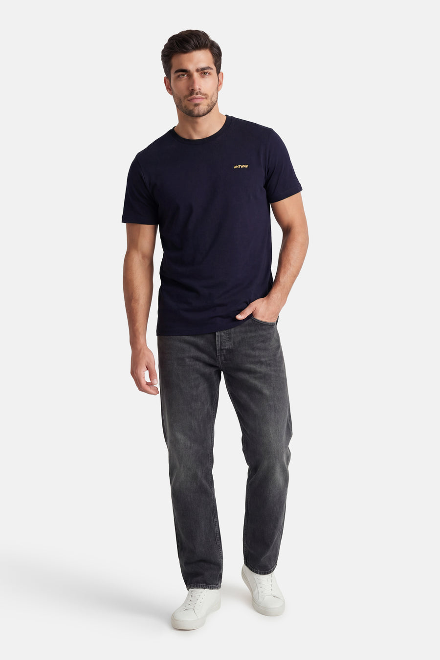 T-shirt à manches courtes bleu par ANTWRP, porté avec un jean gris foncé et des baskets blanches.