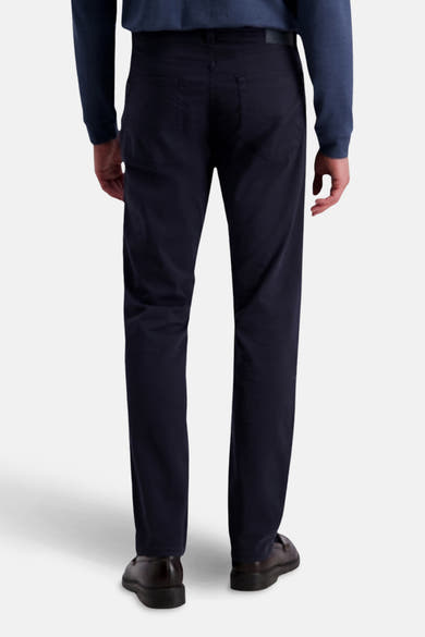 Pantalon coloré bleu par PIERRE CARDIN, coupe droite, porté avec un pull bleu foncé et des chaussures marron, vue de dos.
