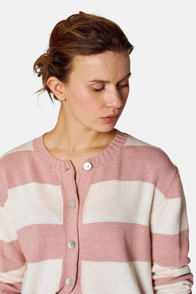 Roze en wit gestreept gilet van COPINES D'ANVERS, met parelmoeren knopen, gedragen door een model dat naar beneden kijkt.