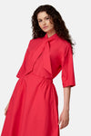 Blouse rose à manches 3/4 de COPINES D'ANVERS avec un nœud-lavallière au col et une taille élastiquée.