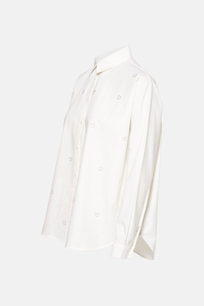 Witte blouse met lange mouwen van NAF NAF, versierd met kleine, discrete hartmotieven.