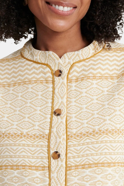 Veste écru de NAF NAF avec motifs géométriques et boutons marron.
