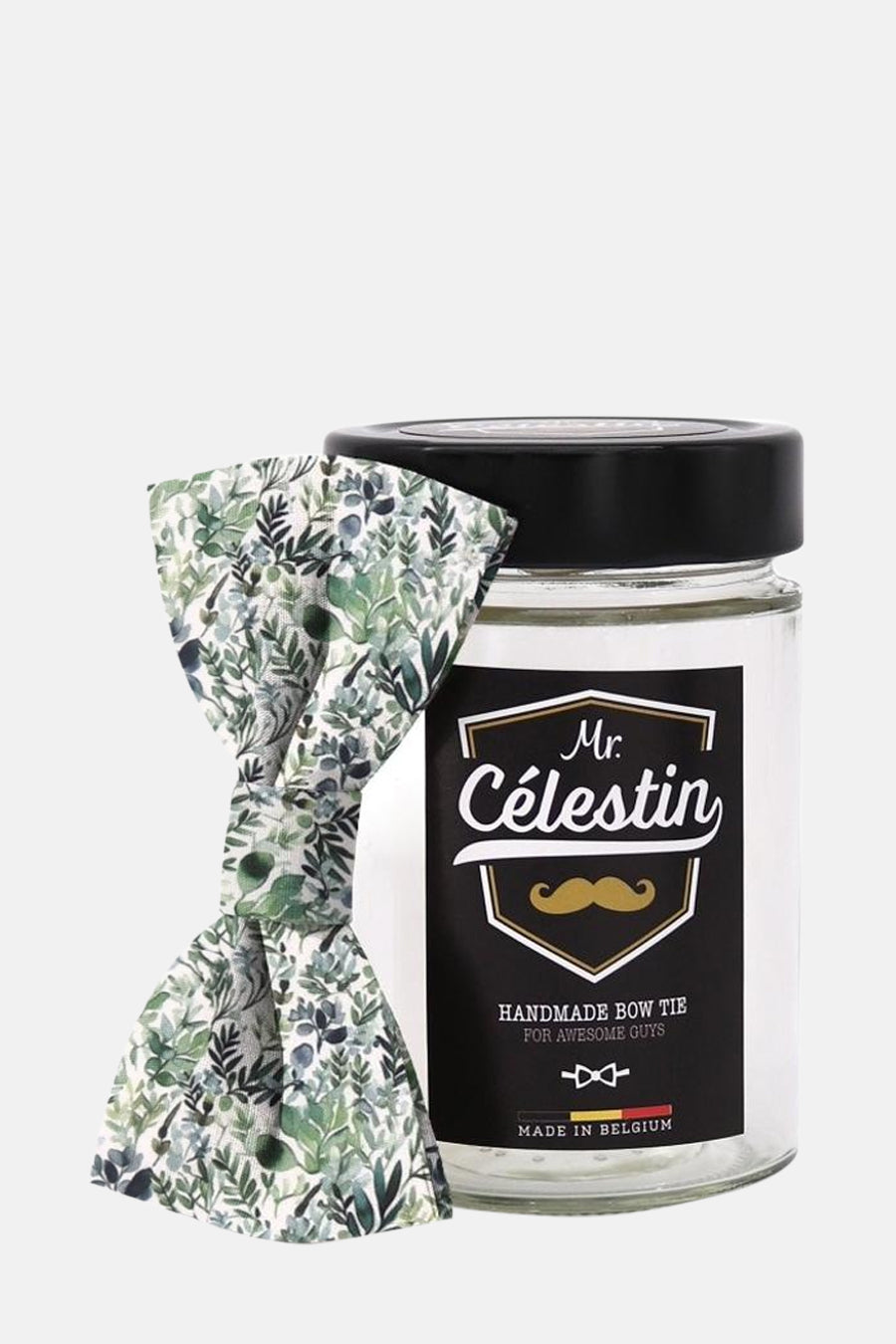Nœud papillon vert à motifs feuillage de Mr. Célestin, présenté dans un bocal en verre.
