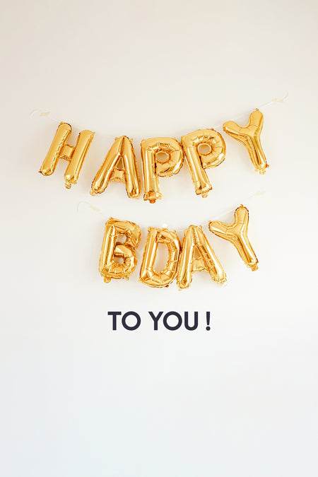 PointCarré verjaardagscadeaubon met gouden ballonnen die de tekst "Happy Bday" vormen.