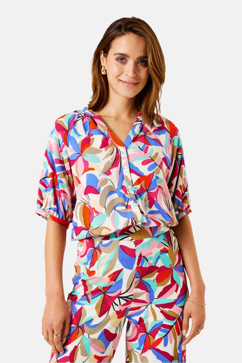 Chemisier à manches courtes multicolore de GARCIA, à motif floral coloré, porté avec un pantalon assorti.