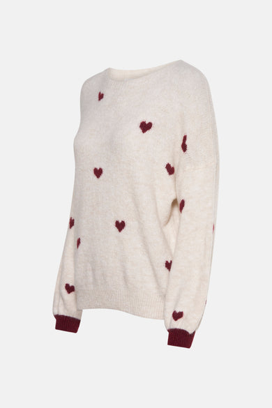 Pull à col rond écru de AMELIE ET AMELIE, motif cœurs bordeaux, manches longues, bords-côtes bordeaux.
