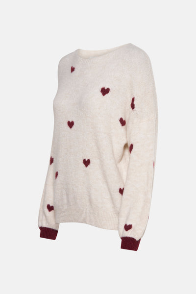 Pull à col rond écru de AMELIE ET AMELIE, motif cœurs bordeaux, manches longues, bords-côtes bordeaux.
