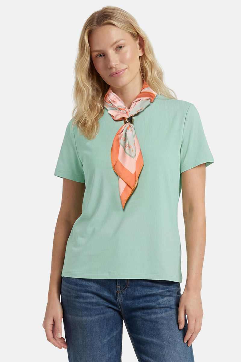 Mint green short-sleeve t-shirt with ribbed texture, worn with floral scarf and blue jeans, front view