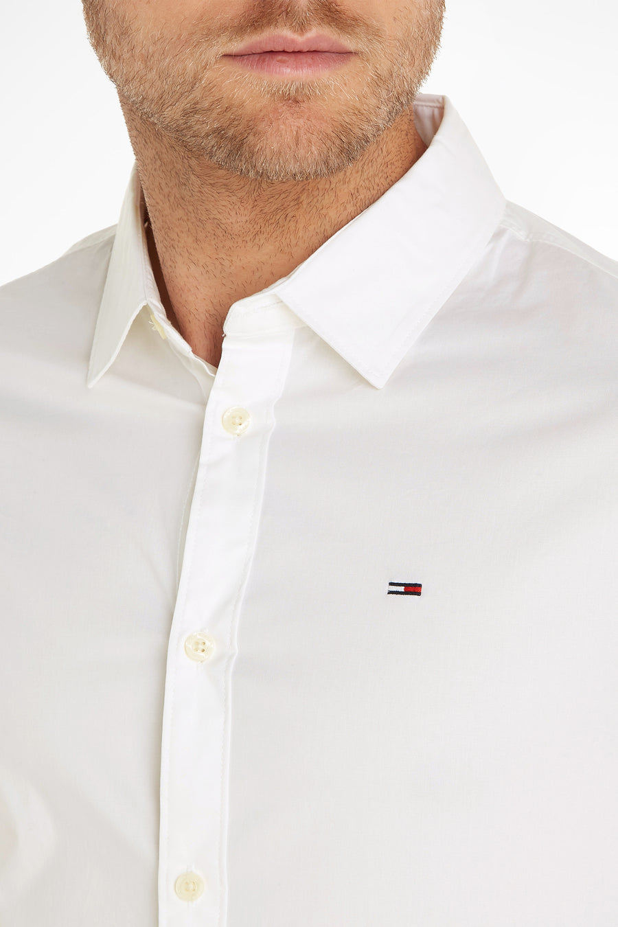 Chemise blanche à manches longues de Tommy Jeans, avec logo brodé et col classique.
