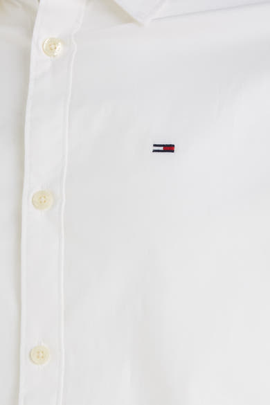 Chemise à manches longues blanche de Tommy Jeans, avec des boutons sur la patte de boutonnage.