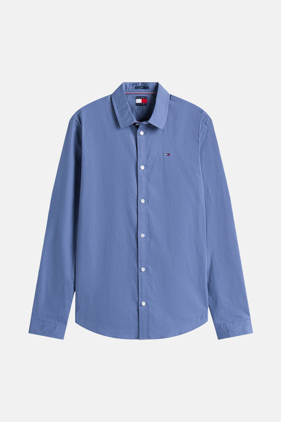 Blauwe blouse met lange mouwen van TOMMY JEANS met knoopsluiting en discreet logo op de borst.