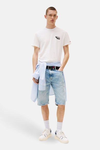 Wit T-shirt met korte mouwen van TOMMY JEANS, met een logo op de borst, gedragen met een spijkerbroekshort en een gestreept overhemd dat aan de taille is geknoopt.