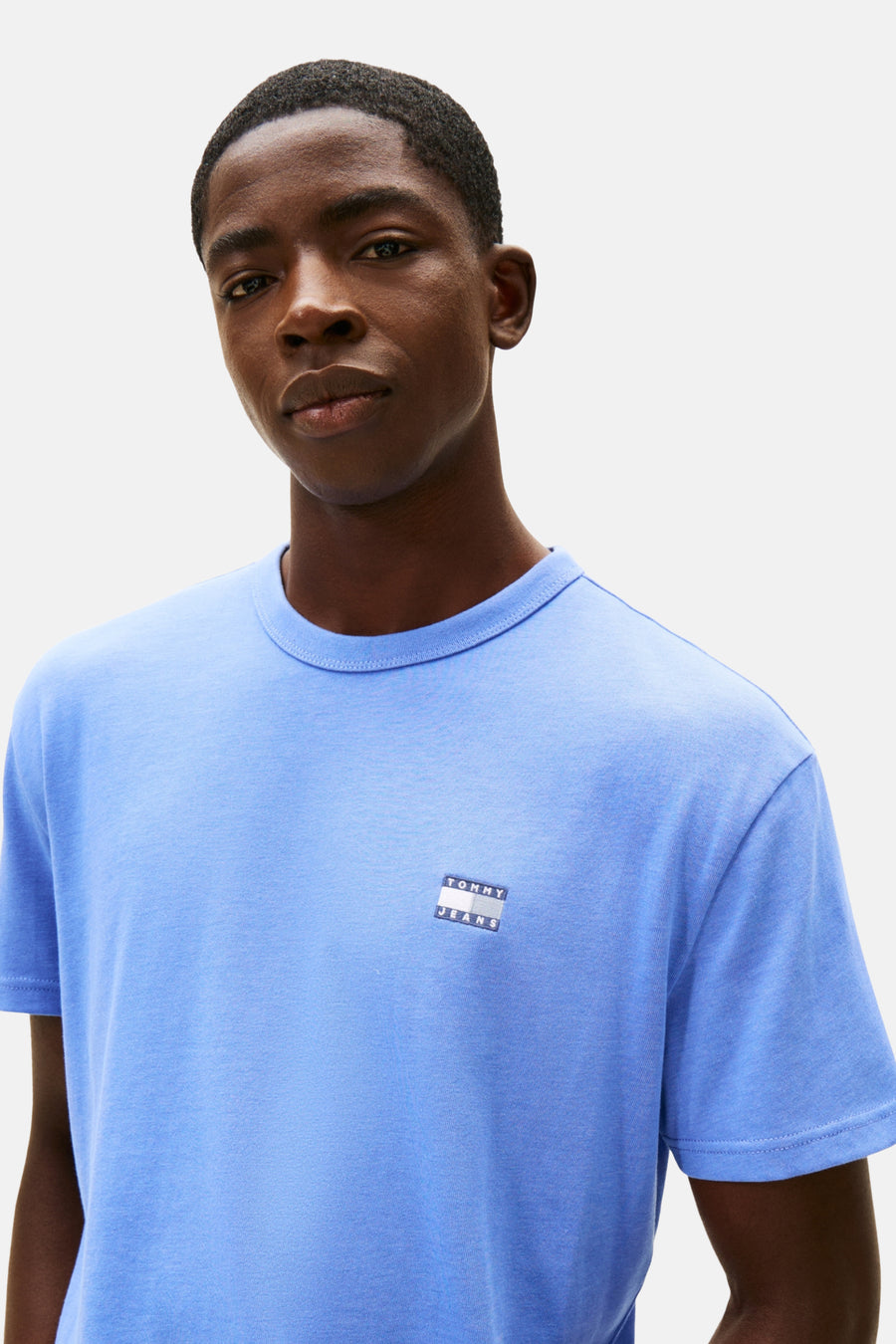 T-shirt bleu à manches courtes de TOMMY JEANS, avec un logo carré sur le côté gauche.