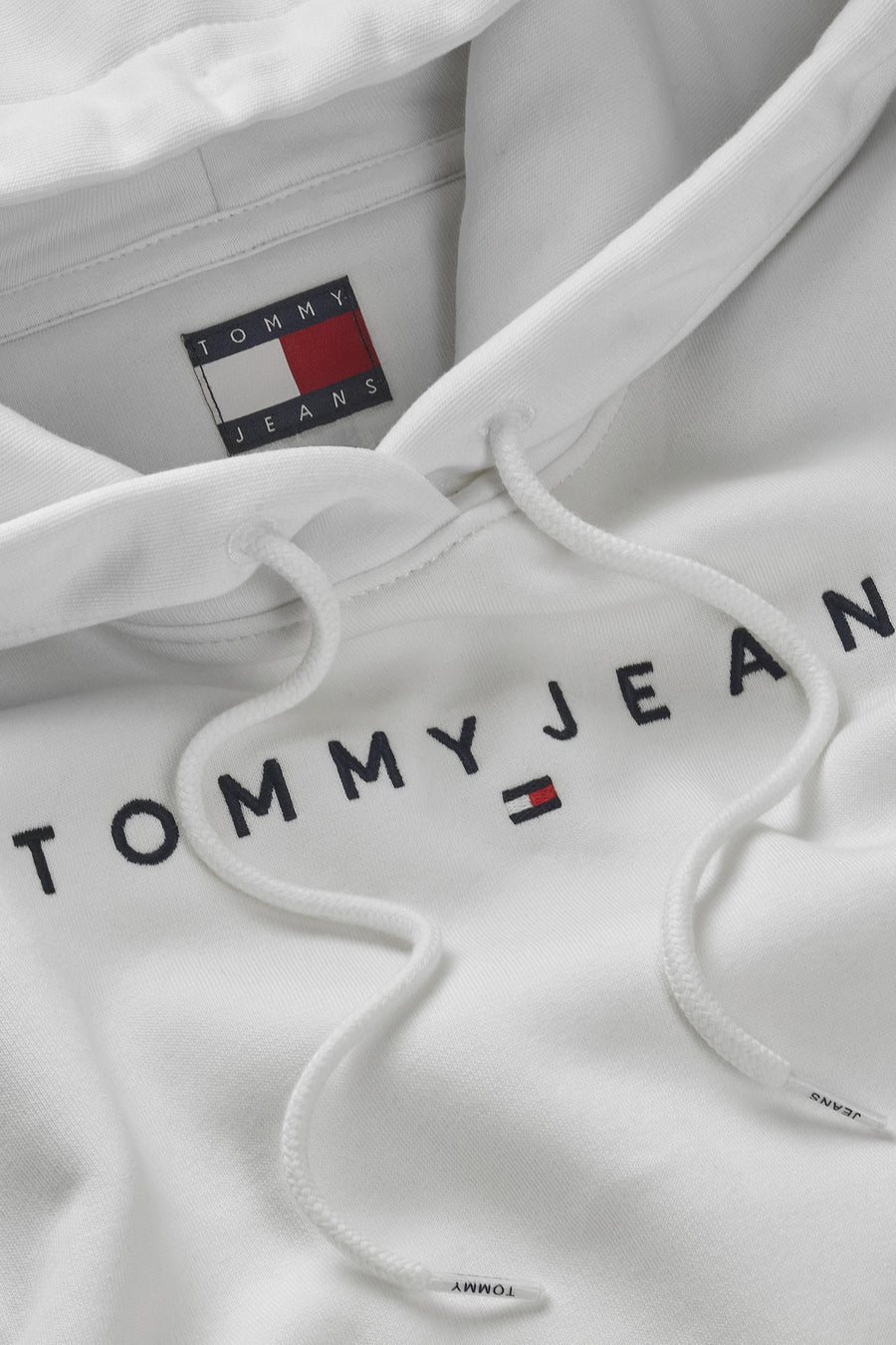 Witte Tommy Jeans hoodie met trekkoorden en geborduurd logo op de voorkant.