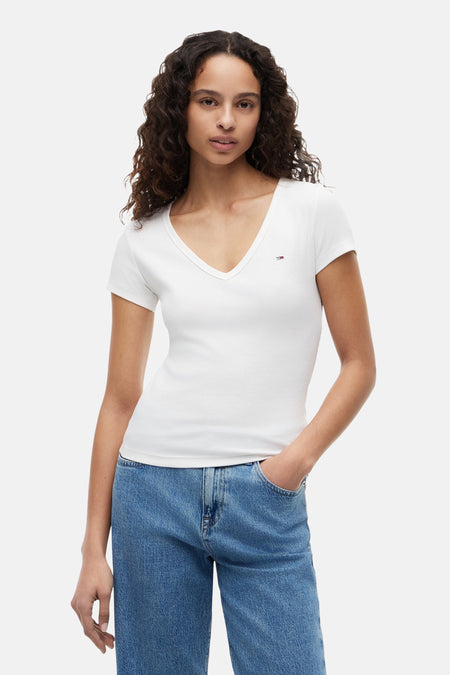 Top uni manches courtes blanc de TOMMY JEANS, avec col en V, texture côtelée et petit logo drapeau.