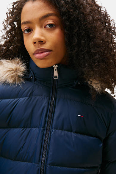 Navy blue quilted puffer jacket with fur-trimmed hood by Tommy Jeans, front zip closure, chest flag logo, close-up view