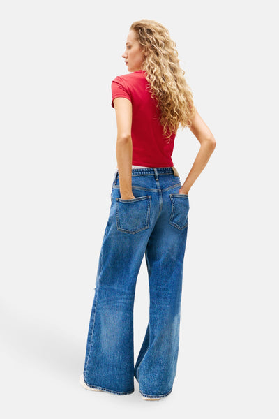 Rood T-shirt met korte mouwen van TOMMY JEANS, gedragen met een wijde high-waist jeans.