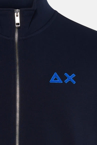 Navy blue fleece jacket with silver zipper and embroidered triangle-X logo on chest, close-up front view