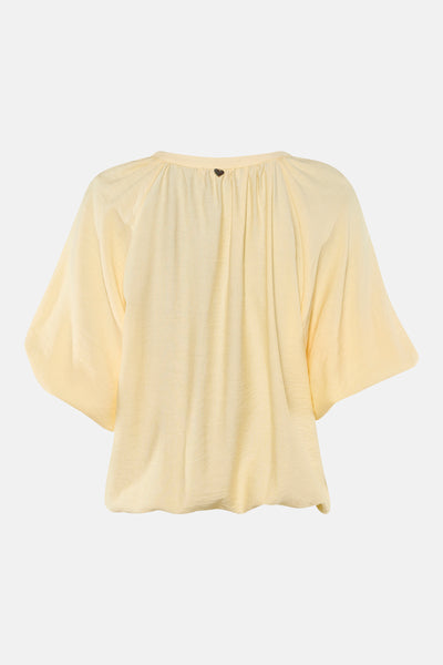 Yellow 3/4 sleeve blouse with gathered back and heart-shaped button, back view