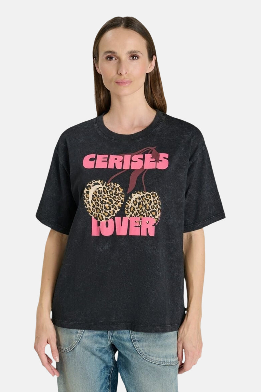 Black short-sleeve T-shirt with pink "CERISES LOVER" text and leopard-print cherries, worn by model in front view.