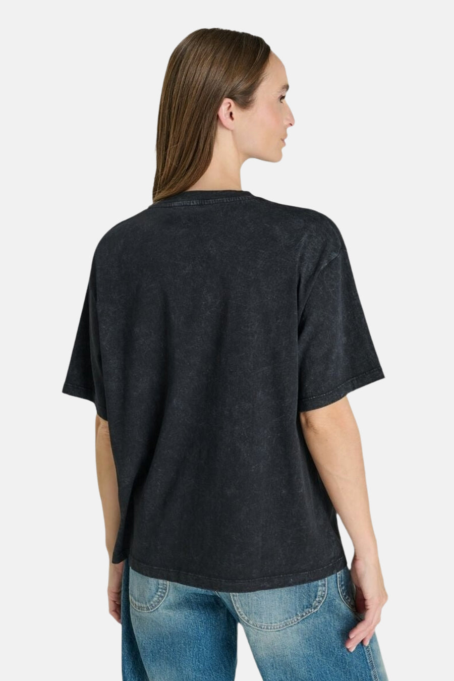Black short-sleeve T-shirt with textured fabric, oversized fit, shown from back view on model wearing blue jeans.