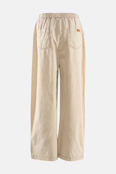 Pantalon beige ample, élastiqué à la taille par ADORE, avec poches carrées plaquées au dos.