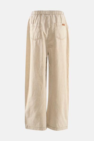 Pantalon beige ample, élastiqué à la taille par ADORE, avec poches carrées plaquées au dos.