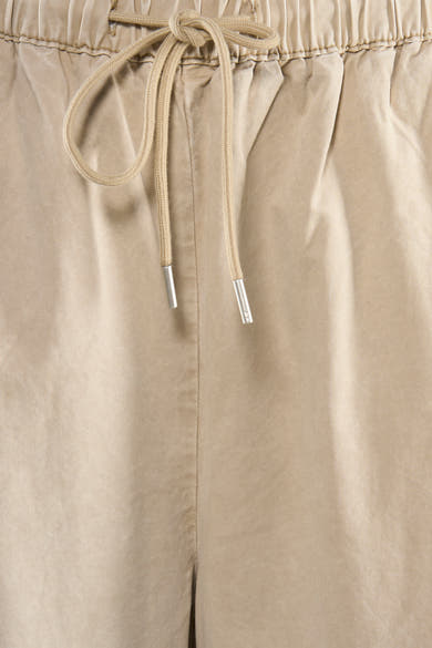 Pantalon beige par ADORE avec cordon de serrage à la taille élastique et détails texturés.