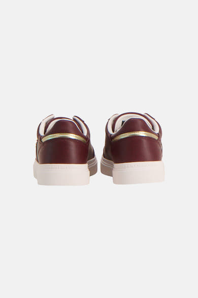 Burgundy leather sneakers by TOMMY JEANS, back view with gold trim and white rubber sole