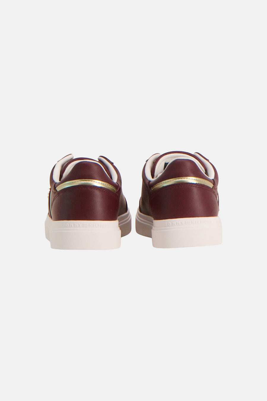 Burgundy leather sneakers by TOMMY JEANS, back view with gold trim and white rubber sole