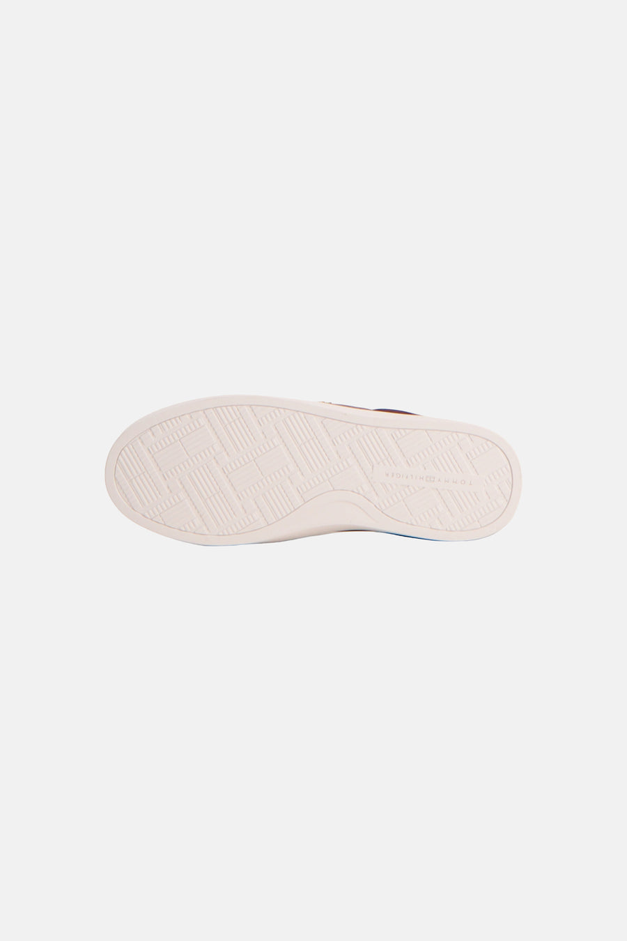 Red sneakers by TOMMY JEANS, white rubber sole with geometric tread pattern, bottom view