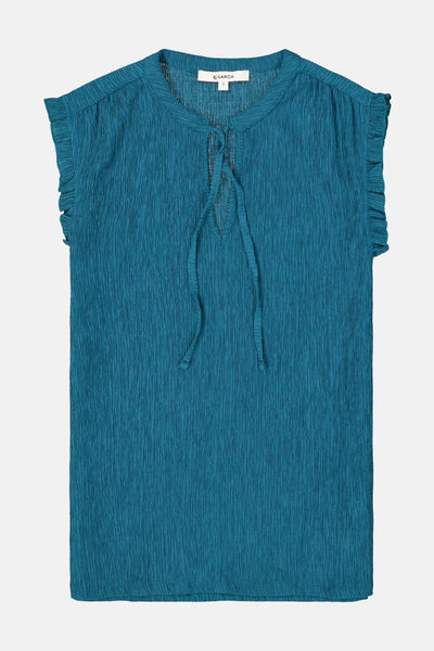 Chemisier turquoise sans manches de GARCIA, texture plissée avec col à nouer et volants aux épaules.
