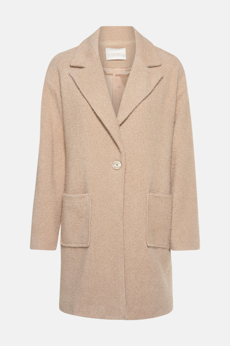 Veste longue beige de AMELIE ET AMELIE avec col tailleur, poches plaquées et boutonnage simple.
