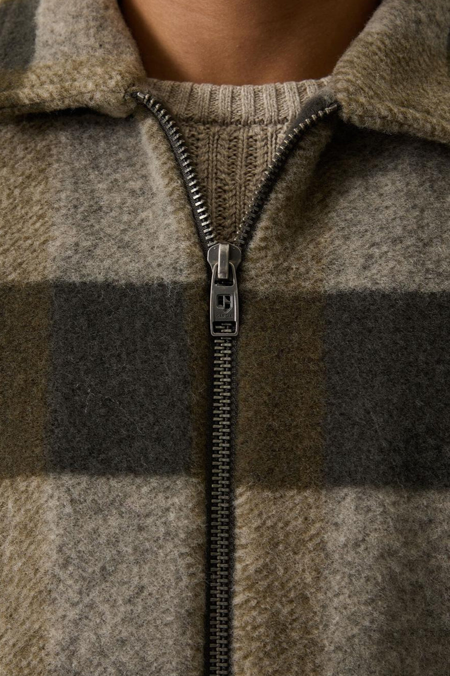 Khaki plaid wool-blend men's casual jacket with ribbed collar and front zipper, close-up view