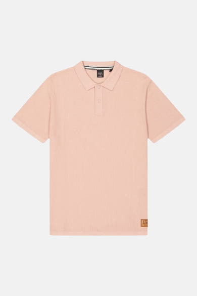 Polo rose de Le Temps des Cerises avec texture gaufrée et patch logo sur le devant.
