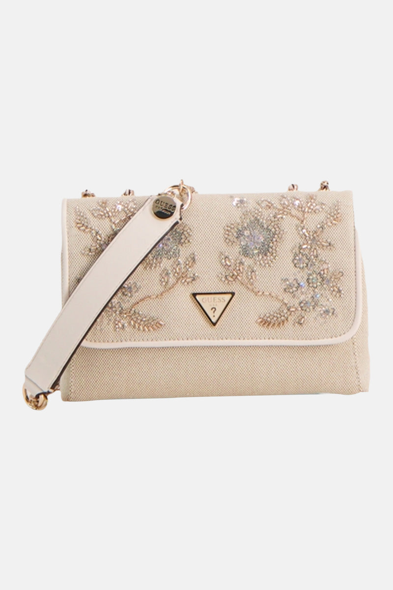Ecru canvas crossbody bag by Guess with floral rhinestone embellishments and gold-tone hardware, front view