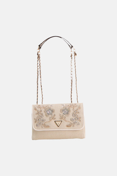 Ecru textured shoulder bag by Guess with floral crystal embellishments and gold-tone chain strap, front view