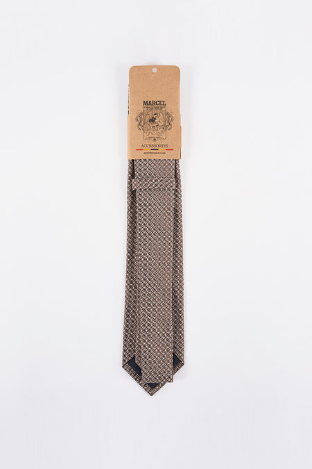 Bruine das met patroon, van Le Fabuleux Marcel de Bruxelles, gepresenteerd in de kartonnen verpakking.