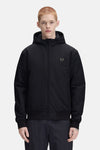 Black hooded waterproof jacket by Fred Perry with olive green laurel wreath logo, front zip closure, and elastic cuffs, shown in front view on model.