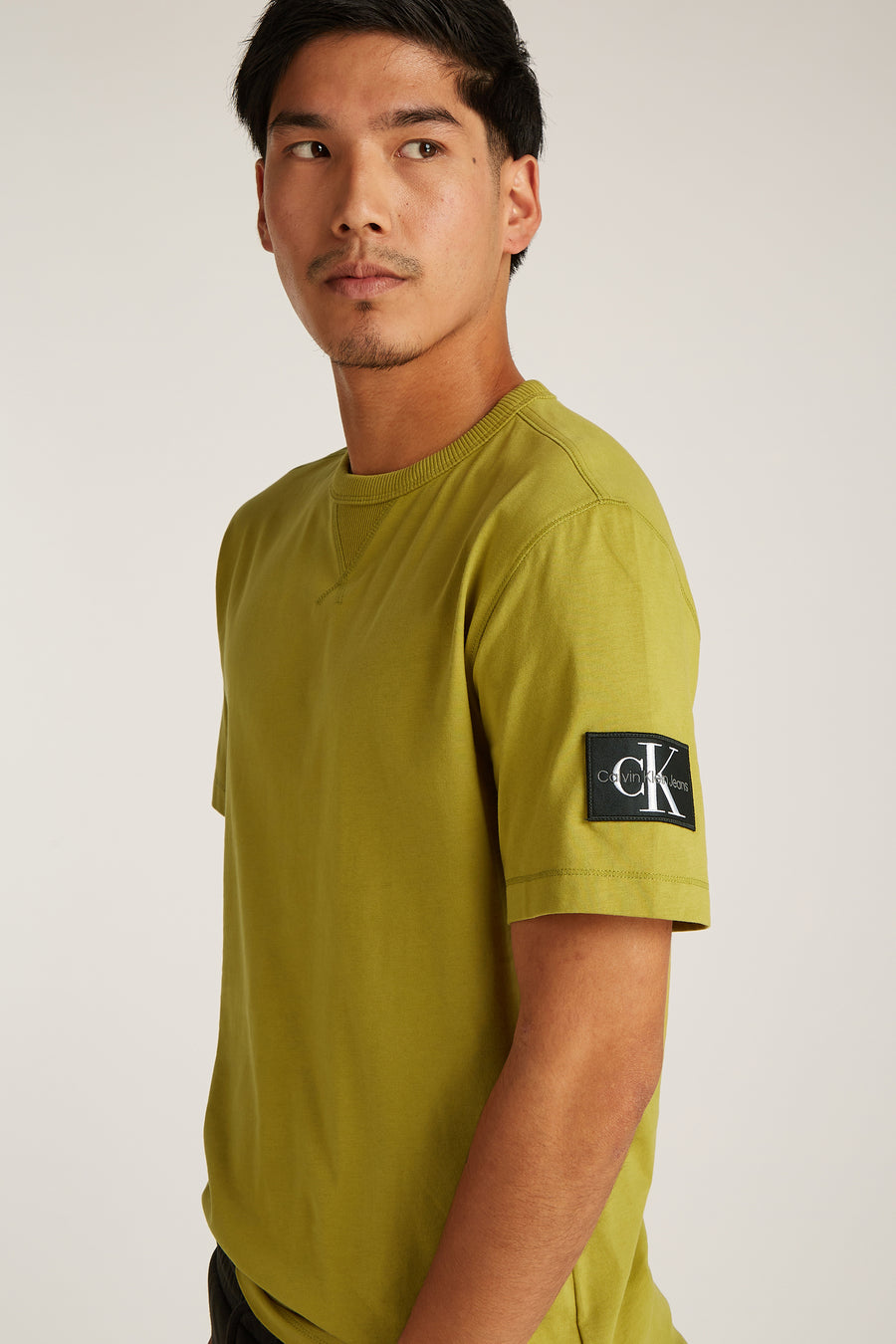Okerkleurig T-shirt met korte mouwen van Calvin Klein, met logopatch op de mouw.