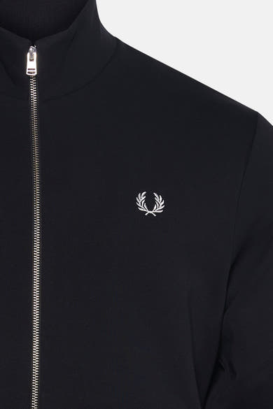 Black zip-front gilet by Fred Perry with white embroidered laurel wreath logo, ribbed collar, and front zipper detail
