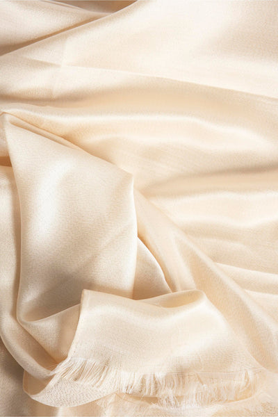 Foulard beige Access® avec une texture plissée douce et des franges décoratives, drapé de manière élégante.
