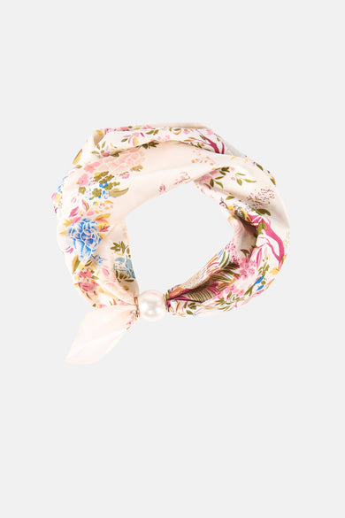 Multicolored floral foulard with cream base and pearl embellishment, tied in a knot, front view