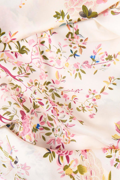 Multicolored floral foulard with soft cream base, pink and green botanical print, delicate fabric texture, close-up view