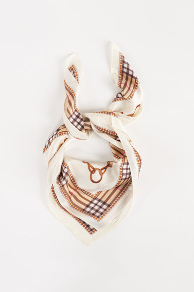 Beige foulard with brown check pattern and dotted border, tied in knot, top-down view