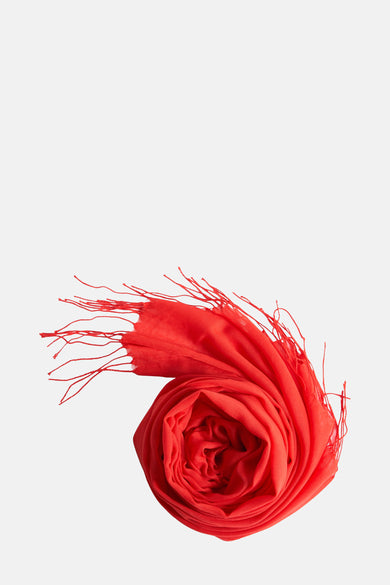 Foulard rouge Access® avec une texture plissée et des franges décoratives, enroulé sur fond uni.