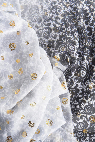 Foulard gris par Access® avec motif floral doré et imprimé contrastant noir et blanc.